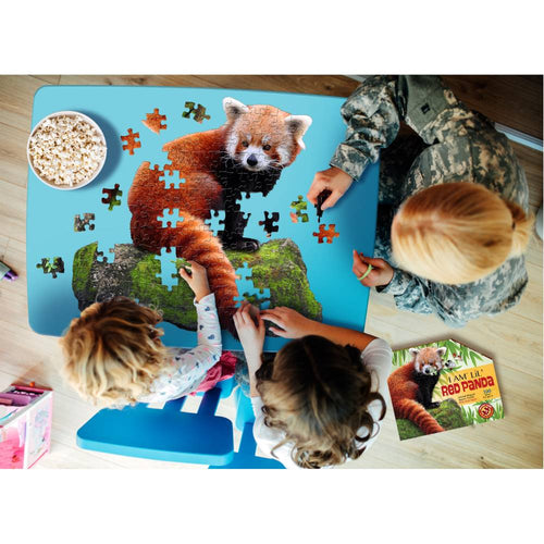 Children and an adult assembling a uniquely shaped red panda puzzle with large pieces on a blue table, surrounded by a snack bowl and educational booklet, part of toys and games collections.