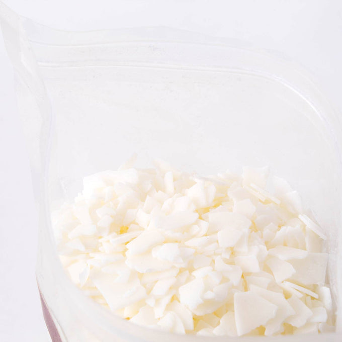 Close-up of handcrafted all-natural white soy wax pellets in a clear resealable bag, featured in Lamps & Lighting, Candles and Candlemaking, Candlemaking Supplies, Best Sellers, and Promo Eligible collections.