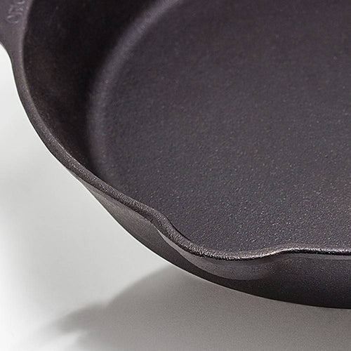 Close-up of a heavy-duty cast iron skillet featuring a long handle and dual pouring spouts, designed for versatile use in Farm, Garden & Tool, Camping, Kitchen & Food, and Best Sellers collections.