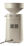Compact electric grain mill with a beige stone-like finish and a large hopper, designed for efficient home flour milling, featured in Kitchen & Food and Grain Mills collections.