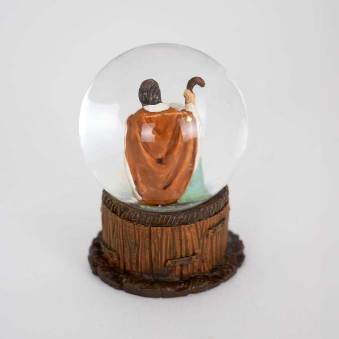 Handcrafted miniature snow globe featuring a detailed Nativity scene with the Holy Family inside a clear globe, set on a rustic wood-textured base, ideal for Home & Decor and Holiday Decor collections.