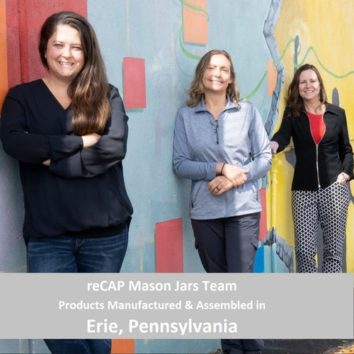 Three smiling women standing in front of a colorful mural wall representing the reCAP Mason Jars team from Erie, Pennsylvania, featured in USA Made, Kitchen Gadgets, and Best Sellers collections.