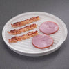 Round white microwaveable grill with raised ribbed surface draining fat from crispy cooked bacon strips and slices of ham, designed for healthier cooking, USA made, Kitchen Gadgets.