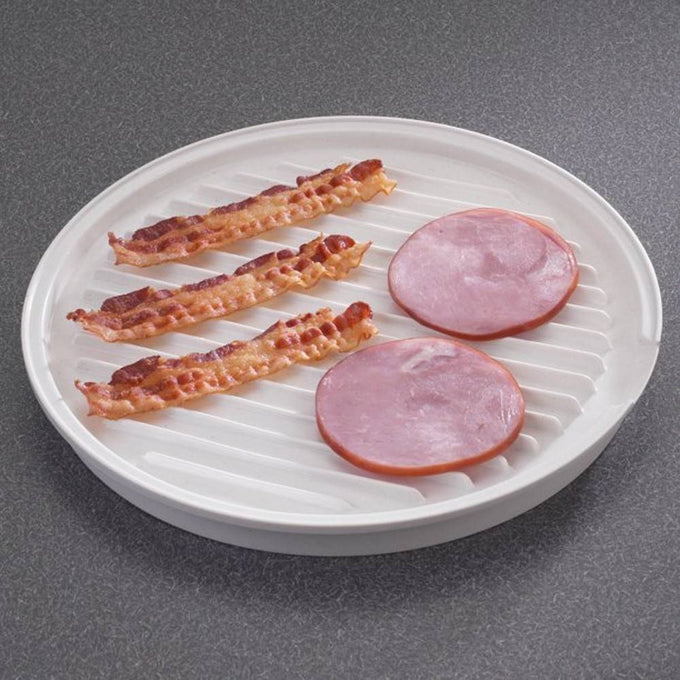 Round white microwaveable grill with raised ribbed surface draining fat from crispy cooked bacon strips and slices of ham, designed for healthier cooking, USA made, Kitchen Gadgets.