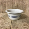 Handcrafted stoneware bowl with a natural cream base and two blue stripes, featuring a pronounced edge, designed for Kitchen & Food, Dinnerware, Storage and Serving collections.