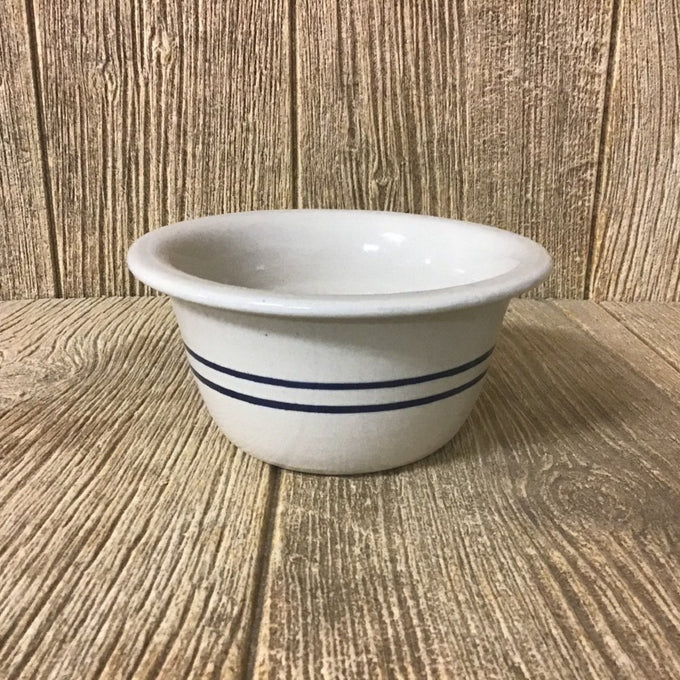 Handcrafted stoneware bowl with a natural cream base and two blue stripes, featuring a pronounced edge, designed for Kitchen & Food, Dinnerware, Storage and Serving collections.