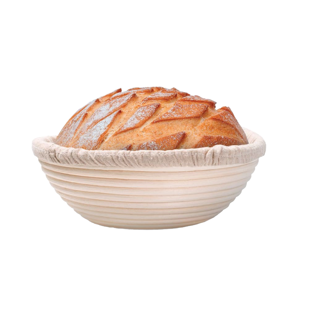 Handcrafted rattan bread proofing basket with a removable cloth liner holding a freshly scored artisan loaf, ideal for Kitchen & Food, Baking Supplies, and Bread Making collections.