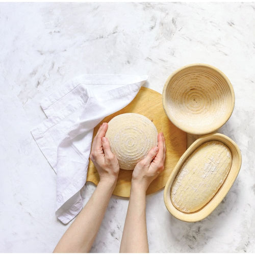Handcrafted rattan proofing baskets with removable cloth liner shown with dough resting on a wooden board and white kitchen towel, ideal for Kitchen & Food, Baking Supplies, and Bread Making collections.