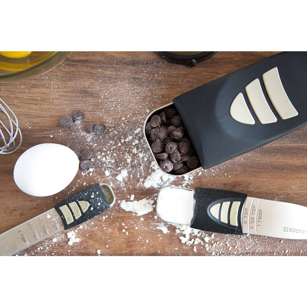 Adjustable measuring spoons and scoop with sliding measurement indicators, surrounded by flour, chocolate chips, and an egg, ideal for Kitchen & Food, Food Prep, and Measuring collections.