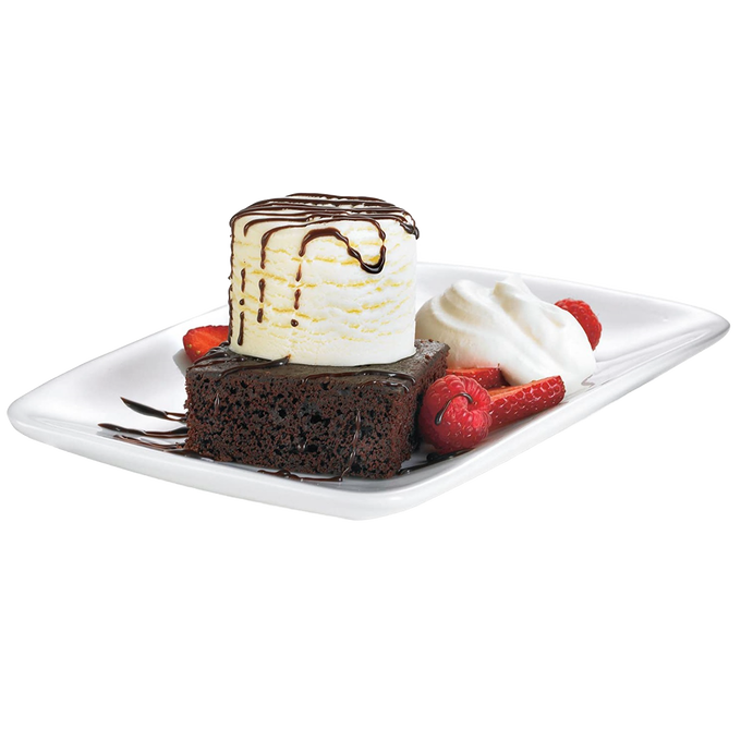 Close-up of a dessert plate featuring a stacked scoop of vanilla ice cream with chocolate drizzle on a chocolate brownie, garnished with fresh raspberries, sliced strawberries, and whipped cream, perfect for Kitchen & Food and Making Ice Cream collections.