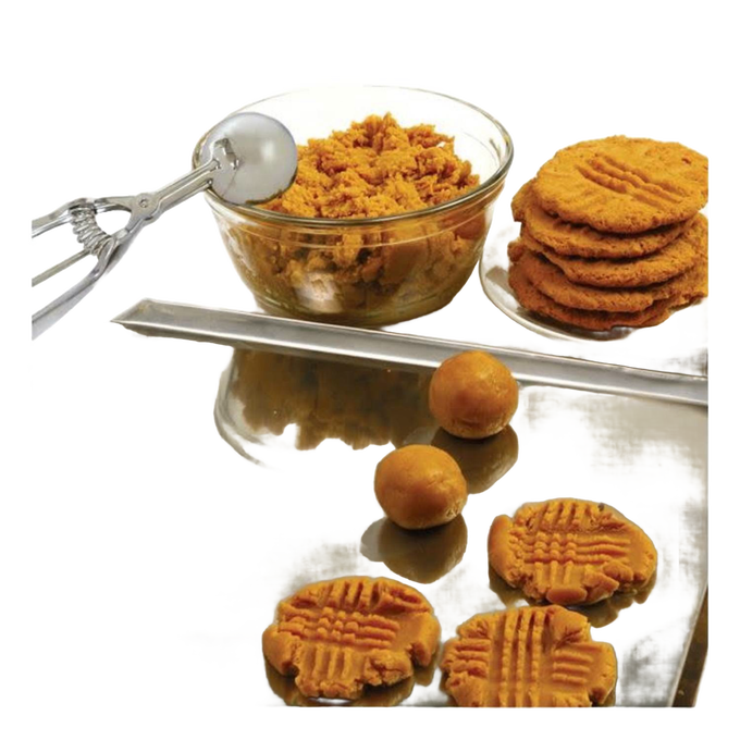 Handcrafted metal scoop with spring release next to a glass bowl of peanut butter cookie dough, freshly shaped dough balls, and baked cookies on a reflective surface, ideal for Kitchen & Food, Cookware, Baking Supplies, Kitchen Gadgets, Cooking and Baking Helpers, Best Sellers, Promo Eligible collections.
