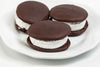 Three handcrafted soft chocolate treats with fluffy white filling on a white plate, part of USA made snacks and sweets collections.