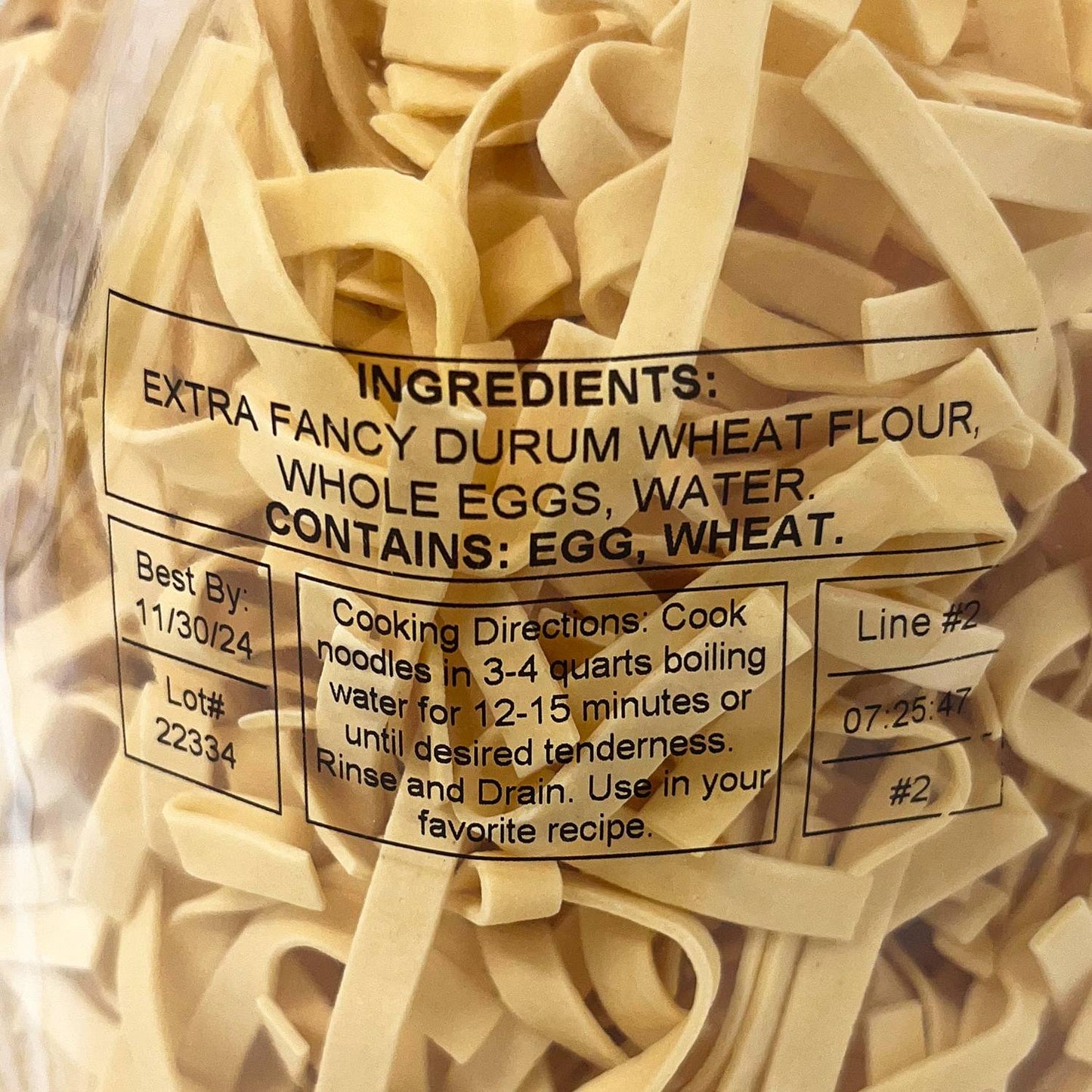 Close-up of a clear bag filled with handcrafted wide egg noodles made from durum wheat flour, whole eggs, and water, perfect for Kitchen & Food, Pantry, USA Made, Best Sellers, and Promo Eligible collections.