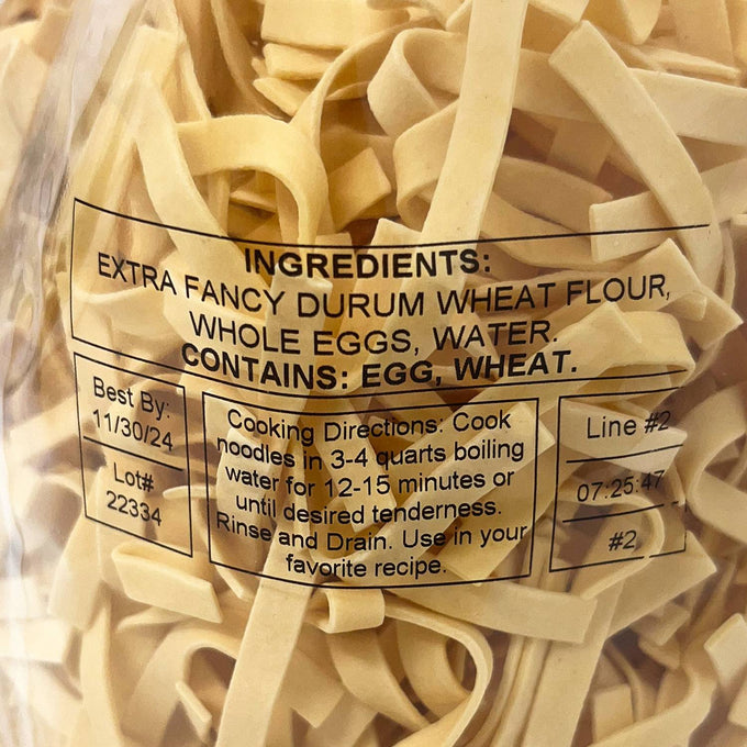 Close-up of a clear bag filled with handcrafted wide egg noodles made from durum wheat flour, whole eggs, and water, perfect for Kitchen & Food, Pantry, USA Made, Best Sellers, and Promo Eligible collections.