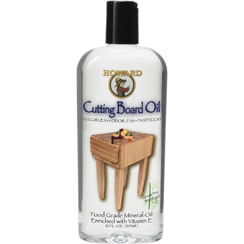 Clear bottle of food-grade mineral oil with black cap labeled for conditioning and seasoning wooden surfaces, shown with a small wooden chopping block, ideal for Kitchen & Food and Food Prep collections.