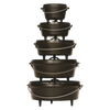 Stacked cast iron ovens with built-in legs and flanged lids for outdoor cooking, crafted in the USA; ideal for camping, farm, garden, and tool collections.