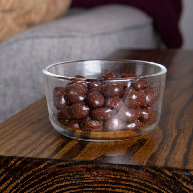 Clear glass bowl filled with glossy handcrafted chocolate covered raisins, showcasing a delicious snack from the Kitchen & Food, Snacks and Sweets, Candy, USA Made, Best Sellers, and Promo Eligible collections.
