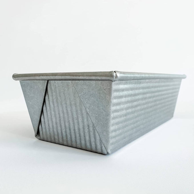 Corrugated aluminized steel loaf pan with nonstick surface, handcrafted in the USA, ideal for even baking, featured in Kitchen & Food, Baking Supplies, and Best Sellers collections.