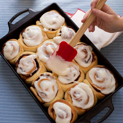 Handcrafted cast iron casserole pan with dual handles, filled with freshly baked cinnamon rolls being frosted, featured in Kitchen & Food, Cookware, Cast Iron, USA Made, Best Sellers, and Promo Eligible collections.