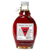 Glass bottle of handcrafted cinnamon cider syrup with a cinnamon stick inside, made in USA, ideal for kitchen, pantry, and apple harvest supplies collections.