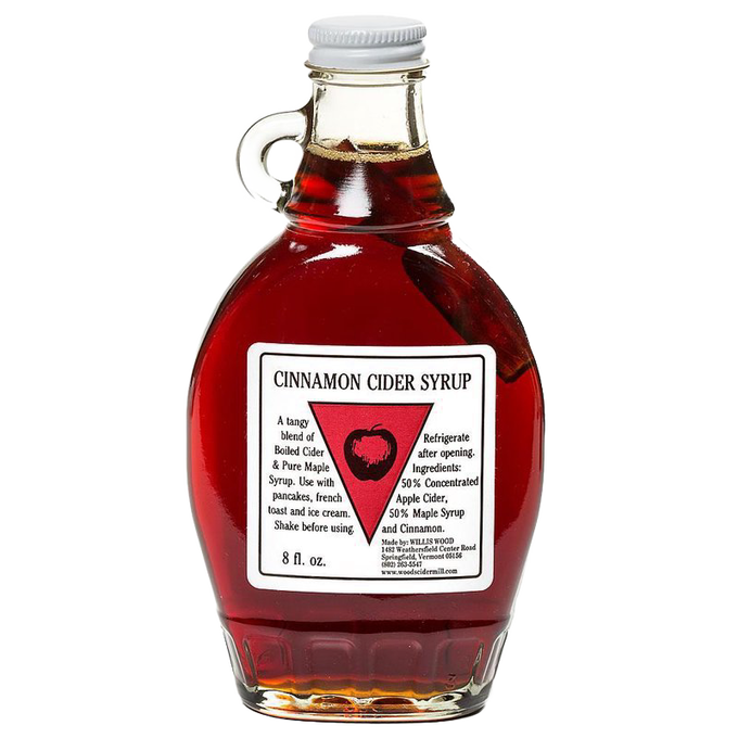 Glass bottle of handcrafted cinnamon cider syrup with a cinnamon stick inside, made in USA, ideal for kitchen, pantry, and apple harvest supplies collections.