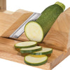 Handcrafted wooden gourmet charcuterie slicer with adjustable sharp blade slicing fresh green zucchini, designed for Kitchen & Food, Food Prep, Choppers and Cutters collections.