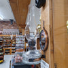 Wall-mounted reflector oil lamp with clear glass base, removable mirror reflector, and tall chimney, handcrafted for Lamps & Lighting, Oil Lamps, Wall Lamps, and Best Sellers collections.