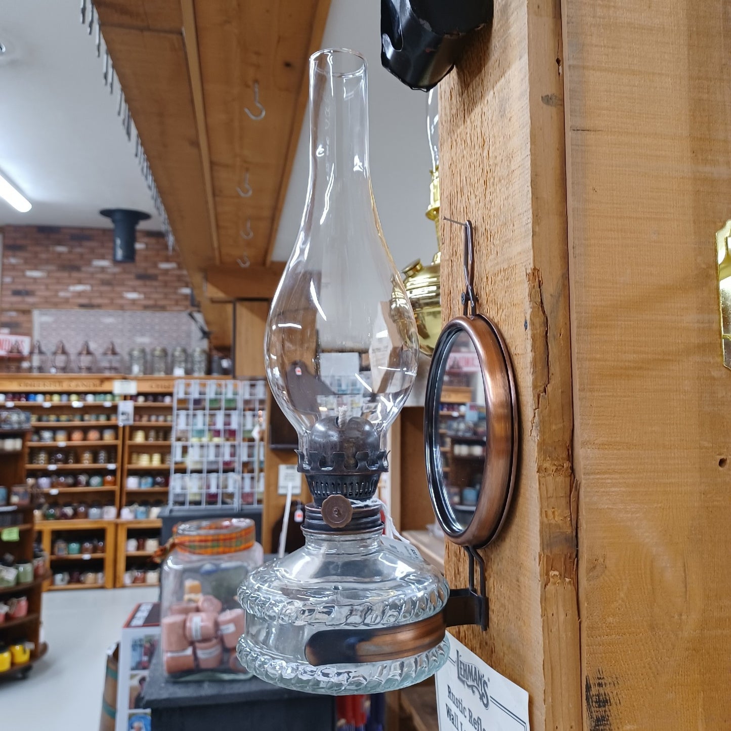 Wall-mounted reflector oil lamp with clear glass base, removable mirror reflector, and tall chimney, handcrafted for Lamps & Lighting, Oil Lamps, Wall Lamps, and Best Sellers collections.