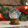 Handcrafted miniature snow globe featuring a glitter-filled glass dome with hand-painted Holy Family figurines inside, set on a rustic wood-style base, perfect for Home & Decor and Holiday Decor collections.