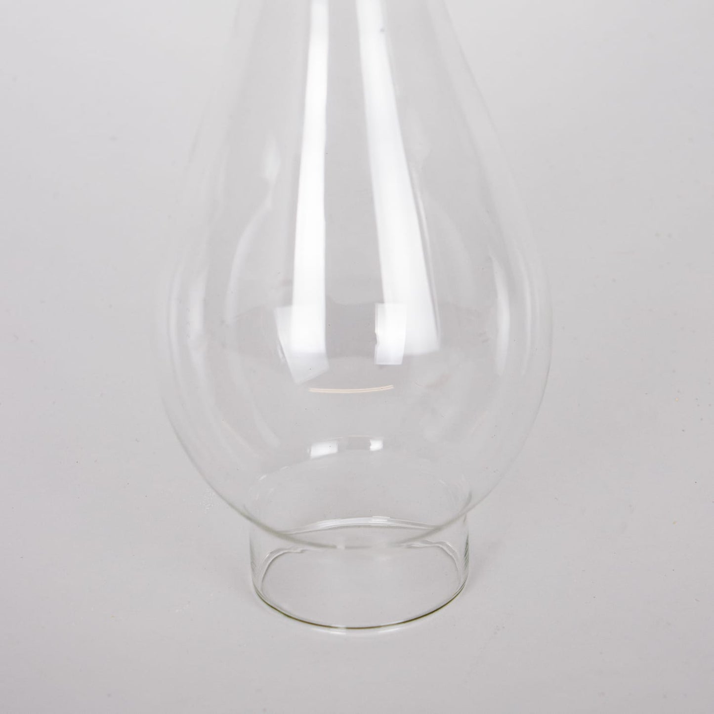 Clear glass oil lamp chimney with 2-inch base, handcrafted for use with various lamps, featured in Lamps & Lighting, Parts and Accessories, Chimneys and Globes, and Best Sellers collections.