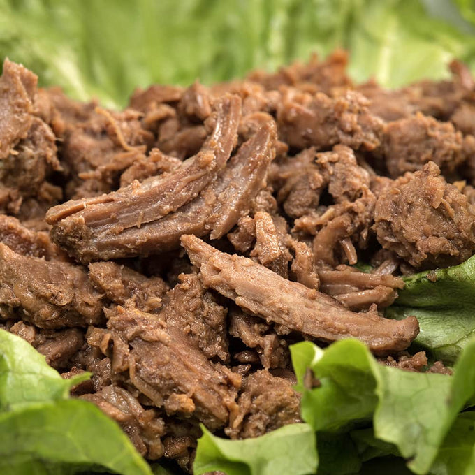 Close-up of tender, handcrafted shredded beef on fresh leafy greens, highlighting a unique all-natural meat option for Farm, Garden & Tool, Kitchen & Food, Emergency Supplies, Food, Meats, and Best Sellers collections.