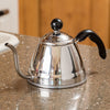 Stainless steel pour-over kettle with a narrow gooseneck spout and angled black handle, designed for precision pouring, featured in Kitchen & Food and Brewing Coffee collections.