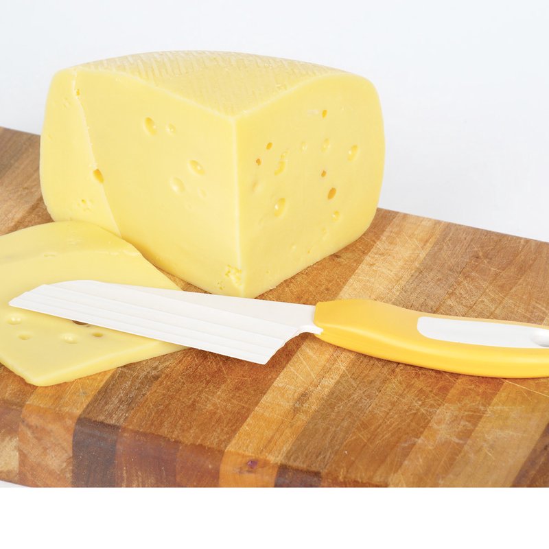 Soft yellow cheese wedge and slice on a wooden cutting board with a handcrafted resin cheese knife featuring a textured drafted blade and comfortable yellow and white handle, USA made, ideal for Kitchen & Food, Food Prep, and Specialty Equipment collections.