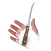 Hand holding a small serrated kitchen knife with a wooden handle, designed for slicing tomatoes and vegetables, crafted in the USA from high-quality materials.