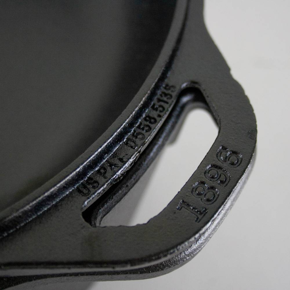 Close-up of a black cast iron double Dutch oven handle showing patent number and model 1896, handcrafted and made in USA, ideal for Kitchen & Food, Cookware, Cast Iron, USA Made, and Best Sellers collections.