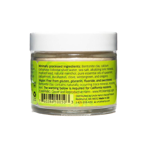 Clear small glass jar with white lid containing handcrafted Uncle Harry’s all-natural alkalizing toothpaste featuring a bright yellow-green label listing natural ingredients, promoting Health & Wellness, Grooming and Personal Hygiene, USA Made, Best Sellers, and Promo Eligible collections.