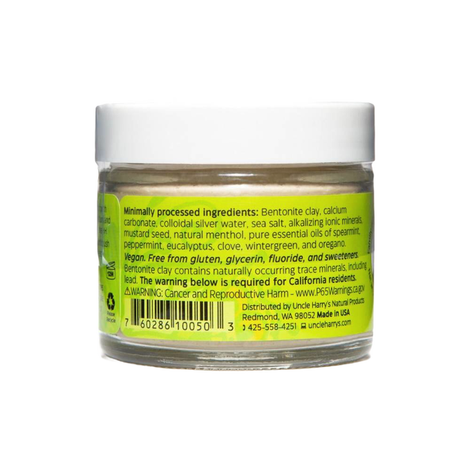 Clear small glass jar with white lid containing handcrafted Uncle Harry’s all-natural alkalizing toothpaste featuring a bright yellow-green label listing natural ingredients, promoting Health & Wellness, Grooming and Personal Hygiene, USA Made, Best Sellers, and Promo Eligible collections.