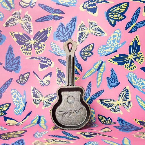 Handcrafted cast iron mini skillet shaped like a guitar with an embossed signature design, made in USA, ideal for Kitchen & Food, Cookware, Cast Iron, USA Made, Best Sellers, and Promo Eligible collections.