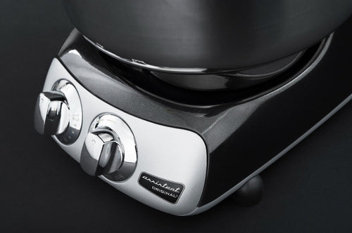 Close-up of a sleek metallic control panel with dual chrome dials on a high-performance mixer base, designed for Kitchen & Food, Baking Supplies, and Kitchen Gadgets collections.