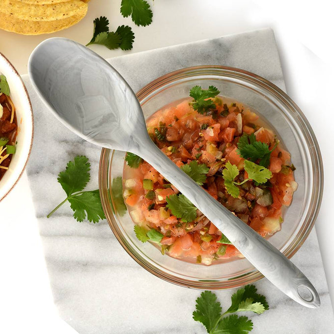 Flexible marble-patterned silicone spoon with a sturdy steel core resting on a glass bowl of fresh salsa, displayed with cilantro and tortilla chips for Kitchen & Food, Cookware, Baking Supplies, Kitchen Gadgets, Cooking and Baking Helpers, Best Sellers, and Promo Eligible collections.