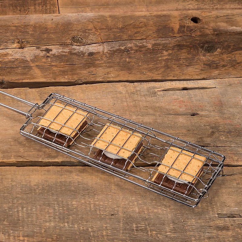 Handcrafted steel basket designed to toast three s’mores simultaneously, featuring graham crackers, chocolate, and marshmallows, ideal for Farm, Garden & Tool, Camping, and Best Sellers collections.