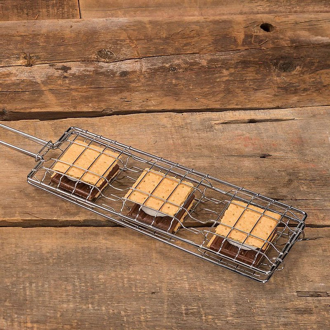 Handcrafted steel basket designed to toast three s’mores simultaneously, featuring graham crackers, chocolate, and marshmallows, ideal for Farm, Garden & Tool, Camping, and Best Sellers collections.