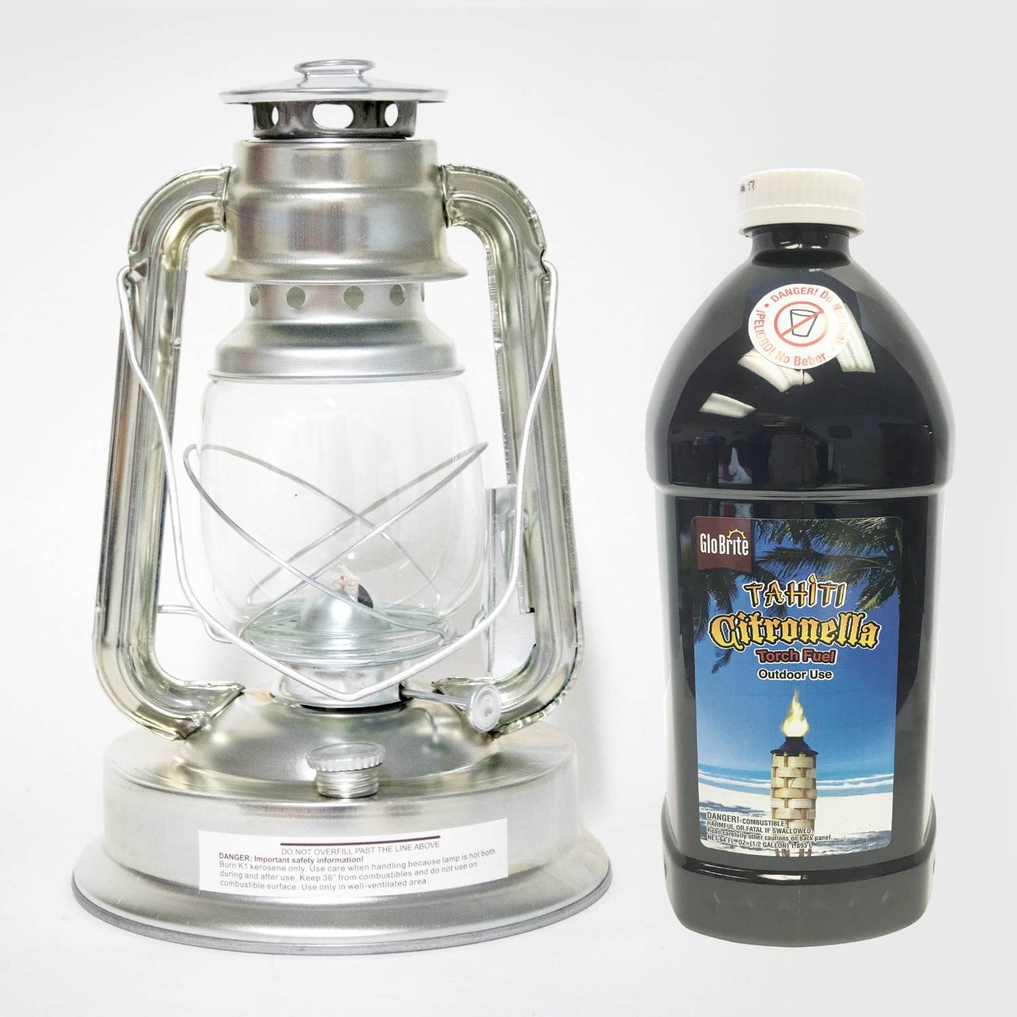 Silver metal oil lantern with clear glass globe next to a large black plastic bottle of citronella fuel, designed for outdoor use in pest control, camping, and farm or garden settings.