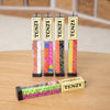 Five sets of colorful dice in clear rectangular containers with vintage-style cream labels reading "TENZI," displayed on a wooden surface, featured in Toys, Books & Games and Table and Board Games collections.