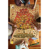Four people assembling a uniquely shaped 1000-piece sugar maple tree puzzle on a wooden table, surrounded by puzzle pieces and a box, featured in Toys, Games, and Best Sellers collections.