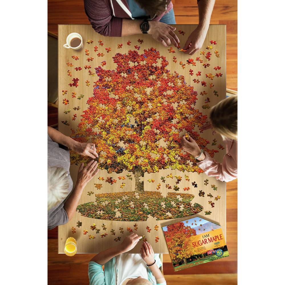 Four people assembling a uniquely shaped 1000-piece sugar maple tree puzzle on a wooden table, surrounded by puzzle pieces and a box, featured in Toys, Games, and Best Sellers collections.
