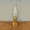 Elegant solid brass table oil lamp with polished finish, classic pearl top glass chimney, finger loop handle, perfect for table or shelf display in lamps and lighting collections.