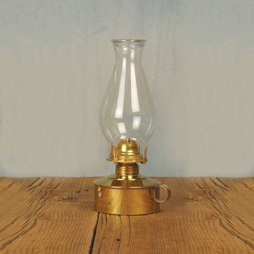 Elegant solid brass table oil lamp with polished finish, classic pearl top glass chimney, finger loop handle, perfect for table or shelf display in lamps and lighting collections.