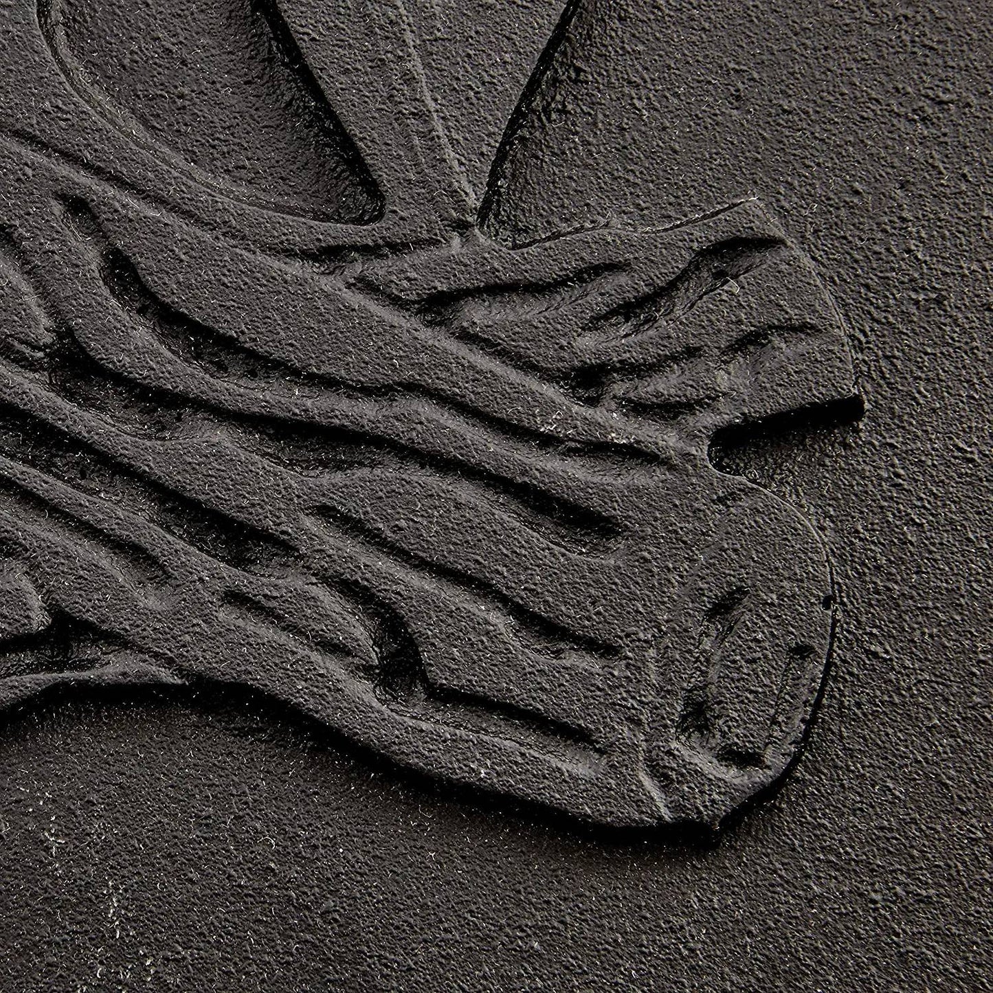 Close-up of a handcrafted cast iron stove door panel featuring detailed embossing of stacked logs, designed for use in stoves, hearth accessories, and heatstoves collections.