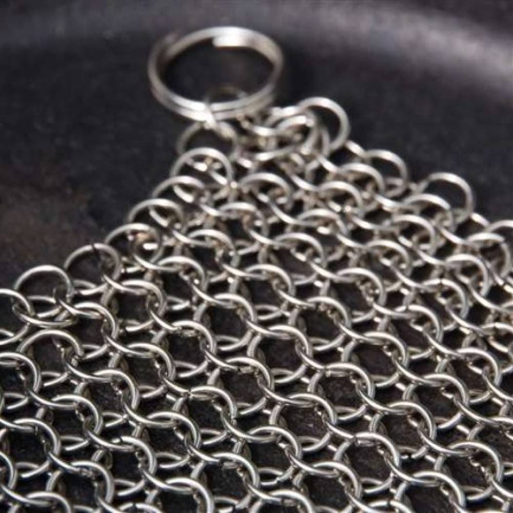 Stainless steel chainmail cleaner with interlocking metal rings and a keyring handle, designed for effortless cleaning of cast and wrought iron cookware, featured in Household Cleaning and Best Sellers collections.